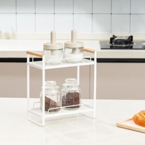 Minimalist white metal spice rack with glass jars on kitchen countertop.