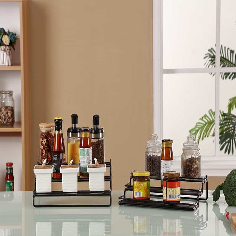 Spice rack with various bottles and jars on a kitchen countertop, organized and stylish.