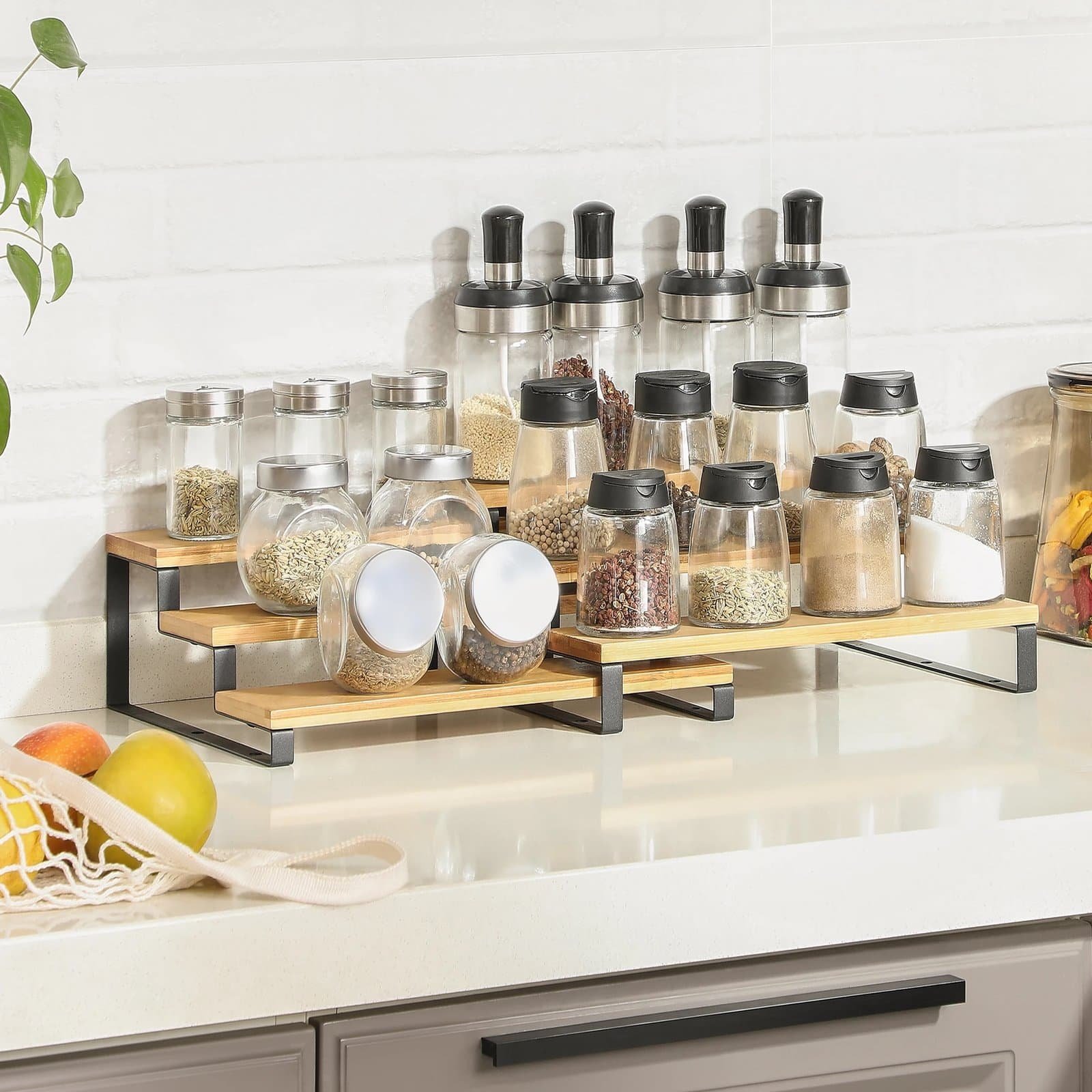 Efficient kitchen spice jar organizer with wooden shelves and glass containers, ideal for kitchen storage.