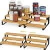 Stackable wooden spice rack organizer with black metal frame for kitchen storage.