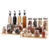 Vibrant spice jars and bottles with herbs, seasonings, and cooking oils on wooden rack.