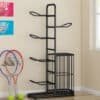 Black ball rack organizer neatly storing footballs and basketballs in a modern room