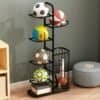 Black ball rack organizer neatly storing footballs and basketballs in a modern room