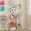 White ball rack organizer neatly storing footballs and basketballs in a modern room
