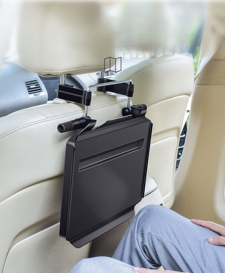 Car tray table folded up behind the seat for space-saving storage.