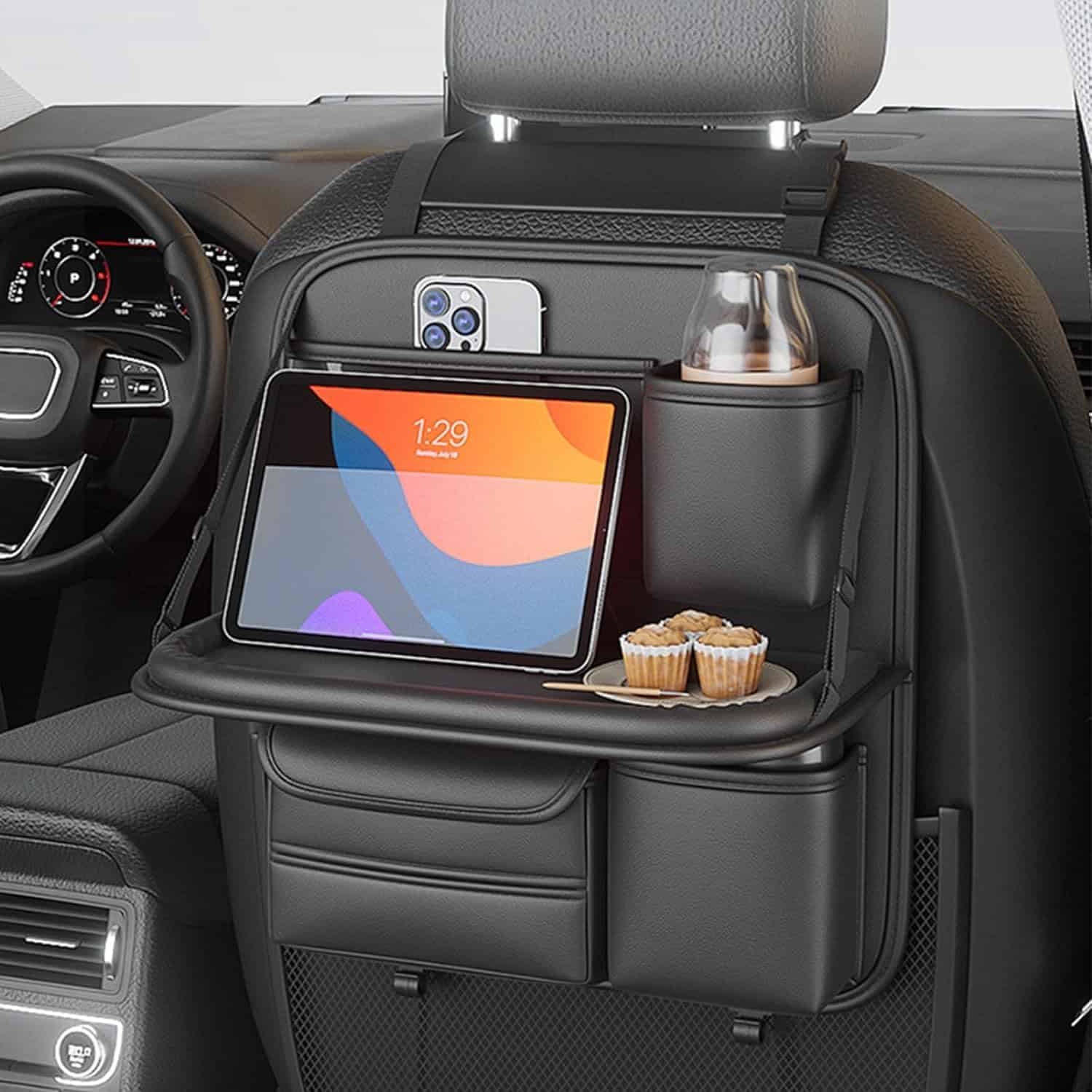 Car back seat organizer with foldable tray holding tablet and drinks – ideal for long drives.