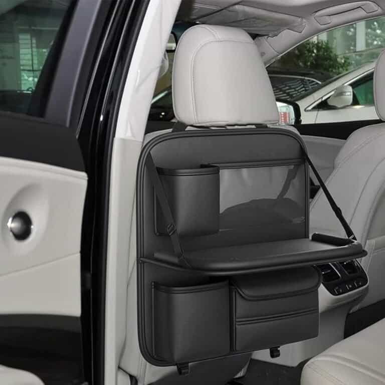 Black leather back seat organizer with cup holder, tray table, and storage pockets.