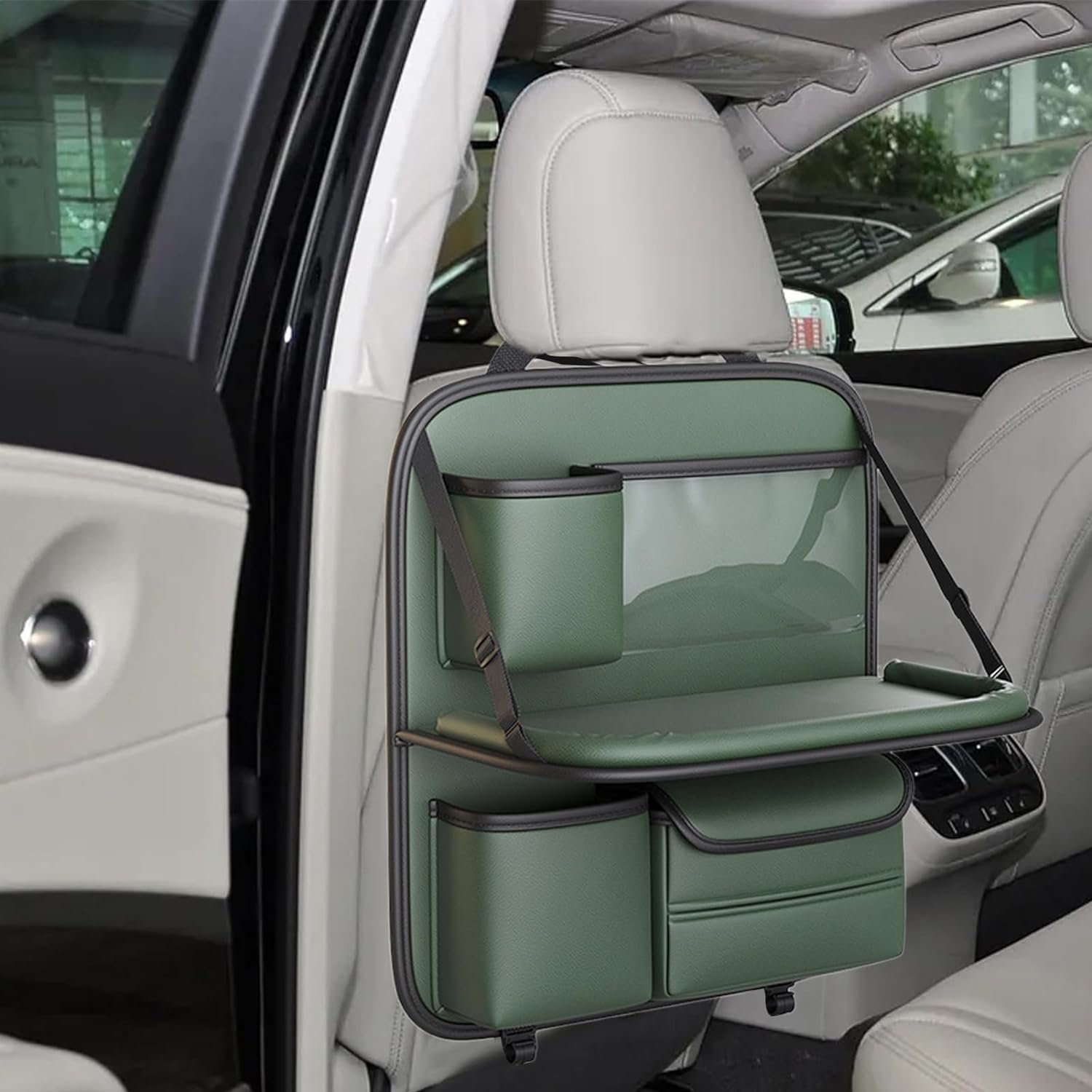 green leather back seat organizer with cup holder, tray table, and storage pockets.