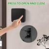 A hand pressing the pop-button to open the wall-mounted key box, with a zoomed-in view of the locking mechanism.