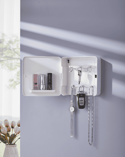 The white organizer box opened, revealing internal key hooks and shelves storing perfume and lipstick.