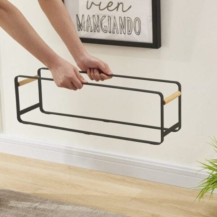 "Modern black shoe rack with stackable tiers holding multiple pairs of shoes"