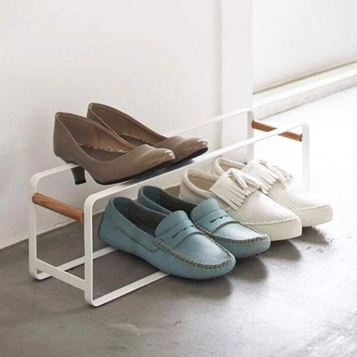 Sleek white shoe rack with stackable design holding multiple pairs of shoes